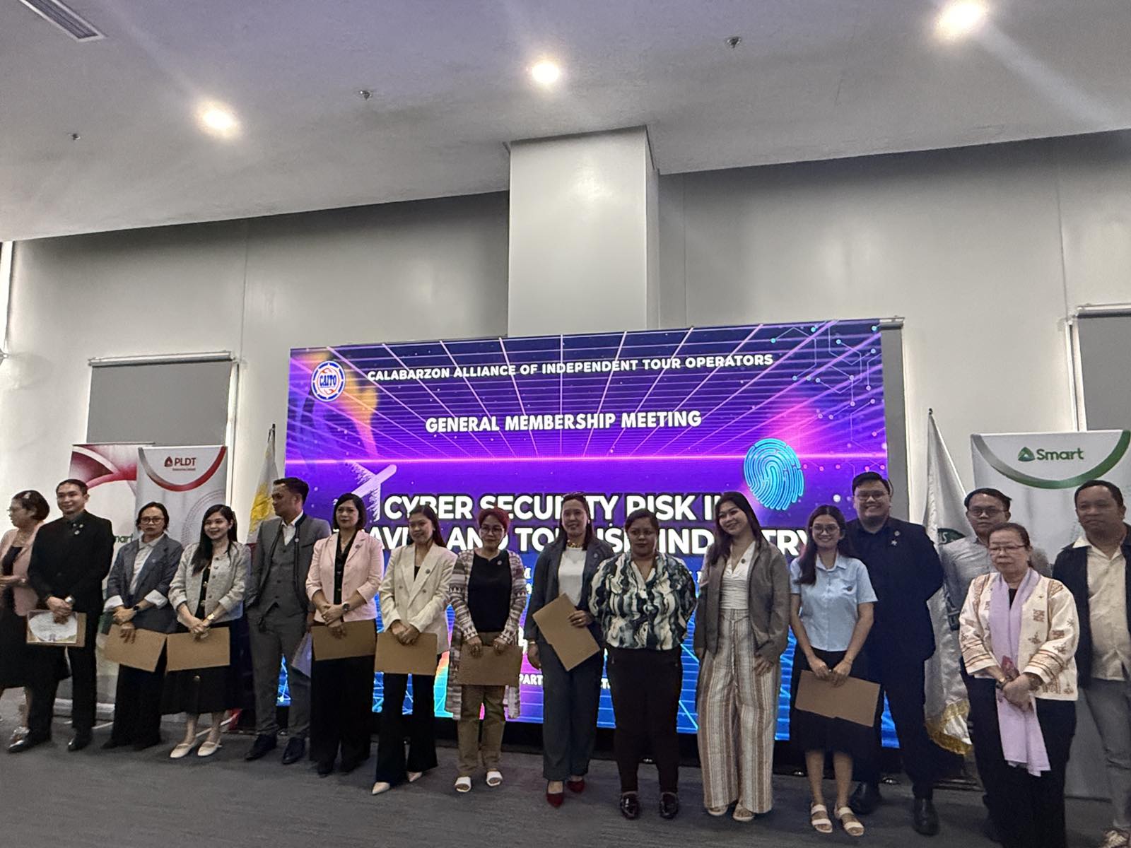CAITO members receiving certificates in front of the general membership meeting backdrop